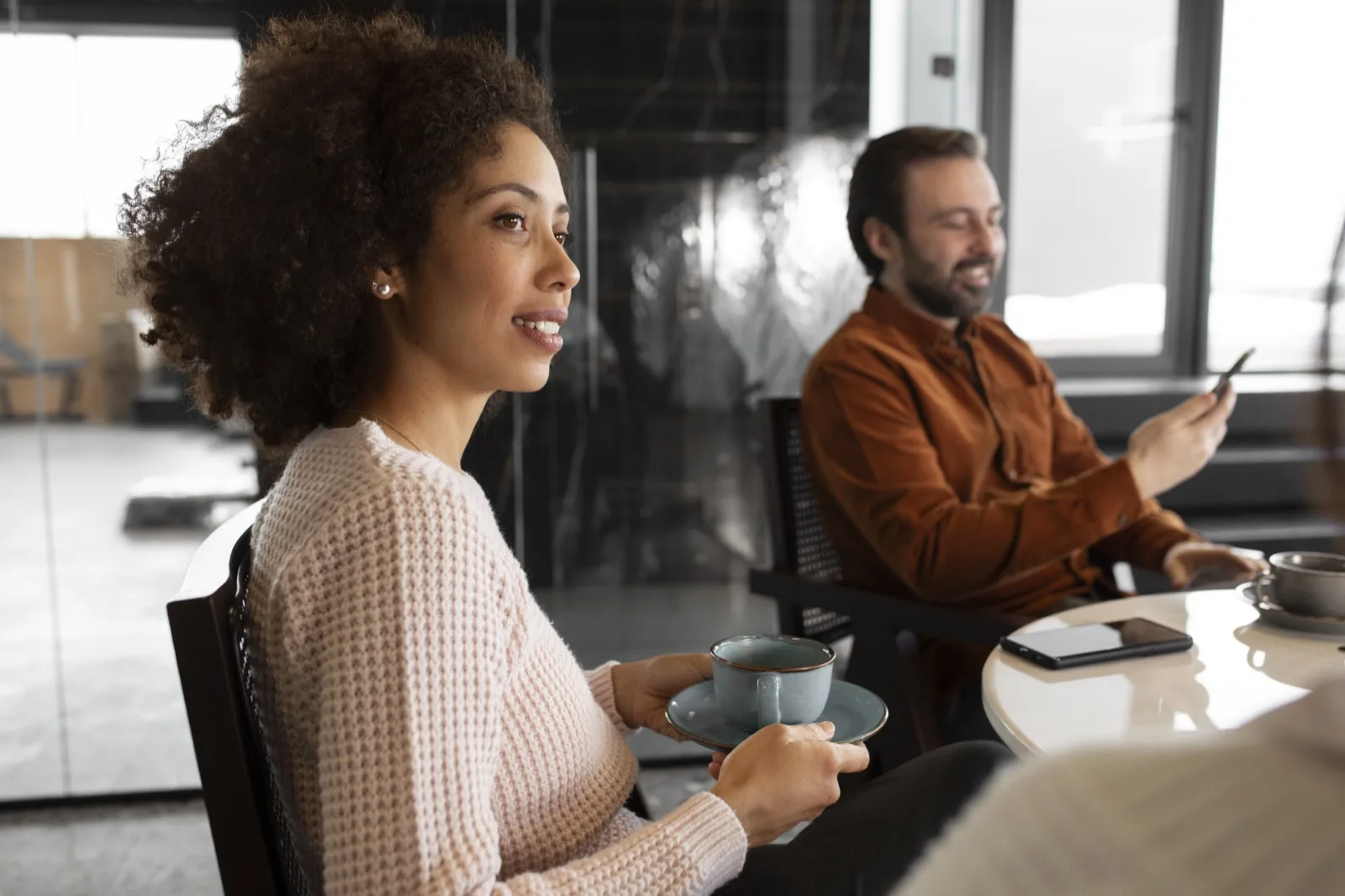 Professional listening attentively at workshop with coffee